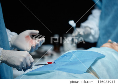 Close up of surgeon performing surgery on unrecognizable patient in operating room copy space Close up of surgeon performing surgery on unrecognizable patient in operating room copy space 116083941
