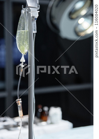 Vertical closeup of IV drip stand with fluids by operating theater in hospital copy space 116084020