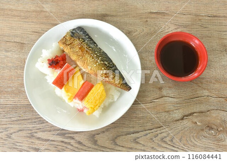 grilled saba fish or mackerel on rice topping sweet egg and crab stick couple pickled cabbage in plate dipping black sweet soybean sauce 116084441