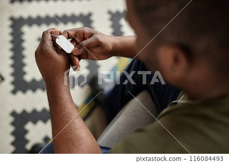Top view close up of Black adult man as army veteran holding dog tags necklace and remembering war copy space 116084493