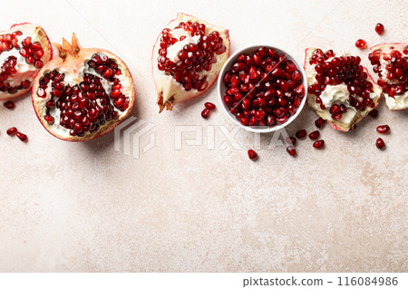 Pomegranate. Fresh organic juicy pomegranate fruit pieces. Pomegranate seeds, grains, top view. Pomegranate. Fresh organic juicy pomegranate fruit pieces. Pomegranate seeds, grains, top view. 116084986