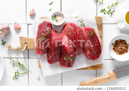 Beef. Raw beef tenderloin meat, beef steaks with ingredients for cooking. Top view Beef. Raw beef tenderloin meat, beef steaks with ingredients for cooking. Top view 116085012
