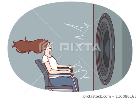 Deafened woman near giant subwoofer from music center listening to loud track sitting in chair 116086165