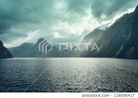 Milford Sound with sunlight shining on Fjord mountain, waterfall and cruising at New Zealand 116086427