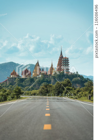 Rural road straight to Wat Tham Sua Temple on hill in Kanchanaburi 116086496