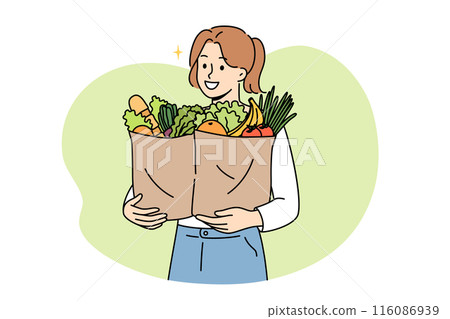 Vegan woman proudly carries paper bags with natural vegetables and fruits bought at farmers fair 116086939