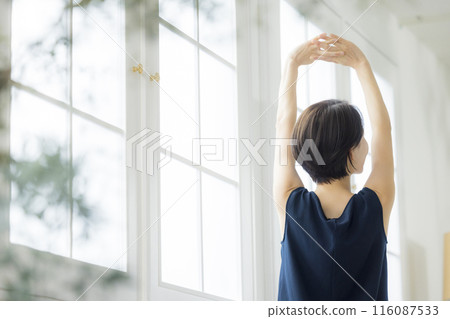 Middle-aged woman doing body care Middle-aged woman doing body care 116087533