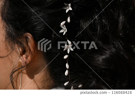 Brunette bride with a white lilies in her hair Brunette bride with a white lilies in her hair 116088428