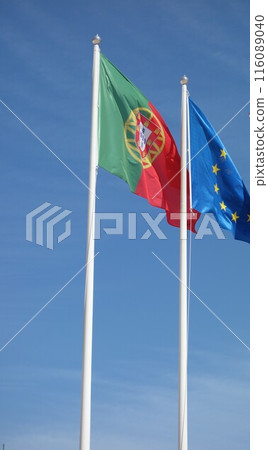 Portuguese and European Union flags waving against blue sky 116089040