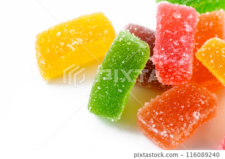 Multi-layered multicolored jelly marmalade of square shape. White background. Close-up 1 116089240