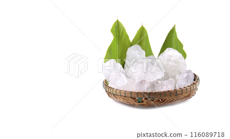 White crystal clear alum cube on green leaf isolated on white background. White crystal clear alum cube on green leaf isolated on white background. 116089718