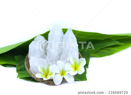 White crystal clear alum cube on green leaf isolated on white background. White crystal clear alum cube on green leaf isolated on white background. 116089720