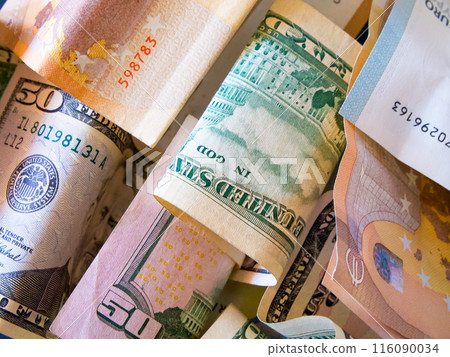 A mix of Euro and US Dollar bills in various denominations. A mix of Euro and US Dollar bills in various denominations. 116090034