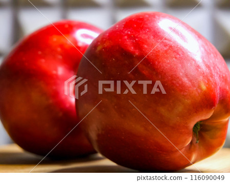 Vibrant Apples. Bright red apples on a wooden board, suitable for culinary arts content. Vibrant Apples. Bright red apples on a wooden board, suitable for culinary arts content. 116090049