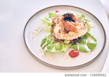 Breakfast of potato pancakes with lightly salted salmon, herbs and cream sauce top view. Delicious vegetable pancakes with salmon on a plate with space to copy. High quality photo Breakfast of potato pancakes with lightly salted salmon, herbs and cream sauce top view. Delicious vegetable pancakes with salmon on a plate with space to copy. High quality photo 116090081