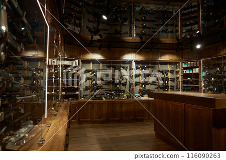 Modern weapon shop interior with guns, handguns, rifles, bullets arsenal Modern weapon shop interior with guns, handguns, rifles, bullets arsenal 116090263