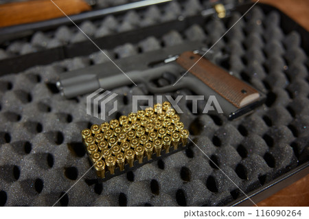 Automatic handgun with bullets in hard case closeup Automatic handgun with bullets in hard case closeup 116090264