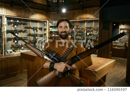 Portrait of happy hunter with purchased ammunition for seasonal hobby 116090397