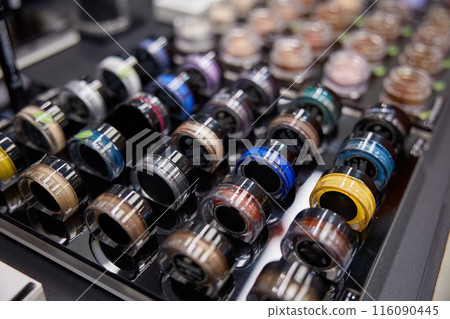 Set of bright colorful eye shadows in cosmetics shop 116090445