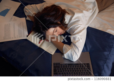Tired exhausted businesswoman falling asleep while working online in hotel room Tired exhausted businesswoman falling asleep while working online in hotel room 116090881