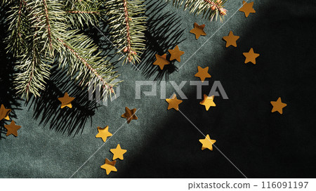 Abstract green velvet Christmas background with Christmas tree branches and gold stars. Abstract green velvet Christmas background with Christmas tree branches and gold stars. 116091197