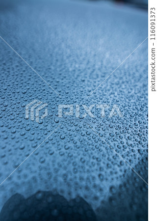 Perfect round water drops on blue car body Perfect round water drops on blue car body 116091373