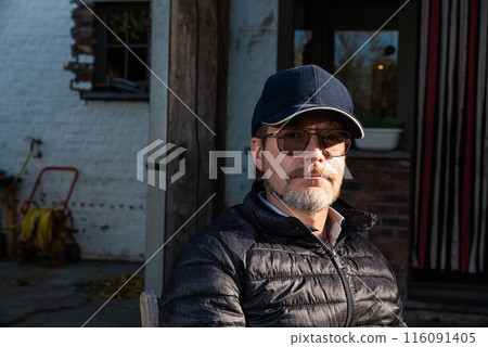 Casual outdoor portrait of a 48 yo white man wearing glasses and a beard, Borchtlombeek, Flanders, 116091405