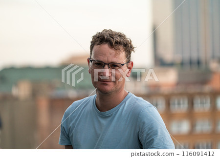 Rooftop portrait of a 45 yo white man in summer, Brussels old town, Belgium 116091412