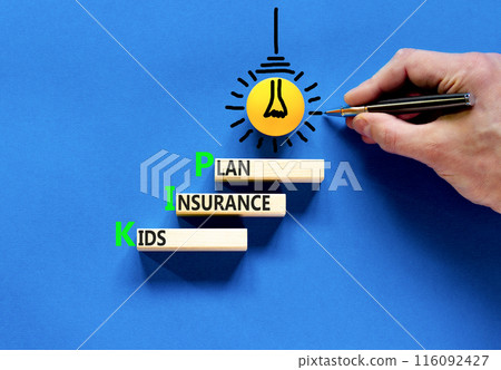 KIP kids insurance plan symbol. Concept words KIP kids insurance plan on beautiful wooden blocks. Beautiful blue background. Businessman hand. Business KIP kids insurance plan concept. Copy space. 116092427