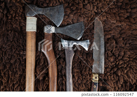 Vintage axes and knife on sheep fur Vintage axes and knife on sheep fur 116092547