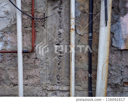 Wires and pipes on the wall to the street. Business communications. Electricity, pipeline. Wires and pipes on the wall to the street. Business communications. Electricity, pipeline. 116092817