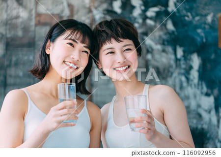 Young woman drinking water Young woman drinking water 116092956