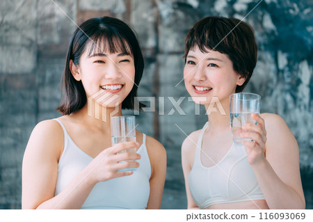 Young woman drinking water Young woman drinking water 116093069