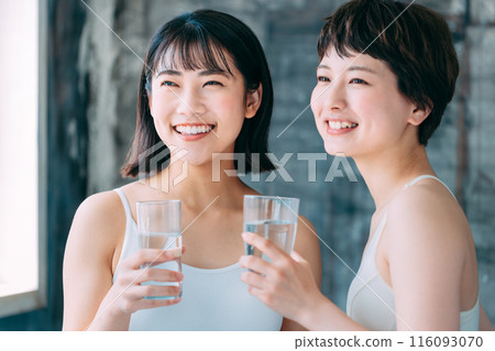 Young woman drinking water 116093070