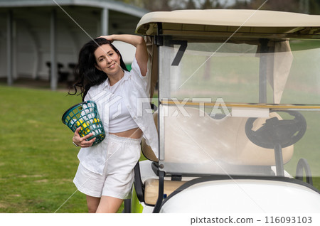 Active woman posing with golf gear by the vehicle outside 116093103