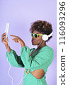 Woman Wearing Headphones and Holding Game Controller 116093296