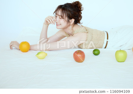 Portrait of a woman surrounded by fruit 116094109