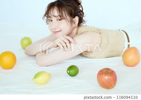 Portrait of a woman surrounded by fruit 116094110