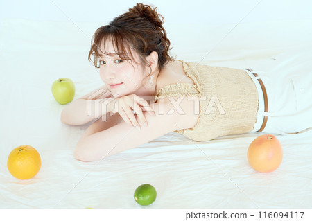 Portrait of a woman surrounded by fruit Portrait of a woman surrounded by fruit 116094117
