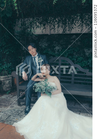 Bride and groom in tuxedo and wedding dress 116095372