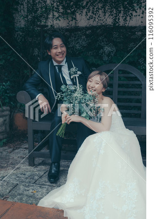 Bride and groom in tuxedo and wedding dress 116095392