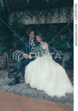 Bride and groom in tuxedo and wedding dress 116095398