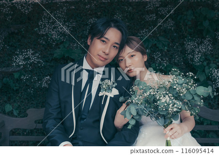 Bride and groom in tuxedo and wedding dress 116095414