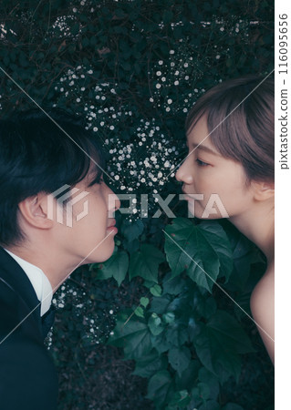 Bride and groom in tuxedo and wedding dress 116095656