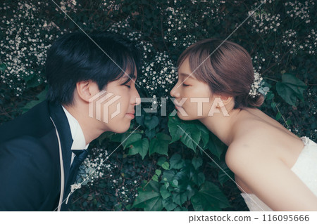 Bride and groom in tuxedo and wedding dress 116095666