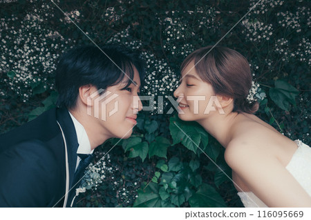 Bride and groom in tuxedo and wedding dress 116095669
