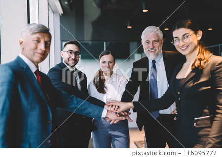 Group of multiracial colleagues standing together in office 116095772