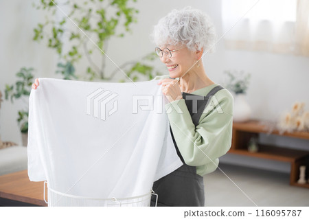 Senior woman who can wash her clothes neatly and the towels are comfortable Senior woman who can wash her clothes neatly and the towels are comfortable 116095787