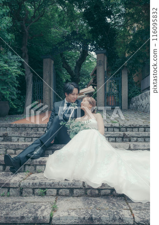 Bride and groom in tuxedo and wedding dress 116095832