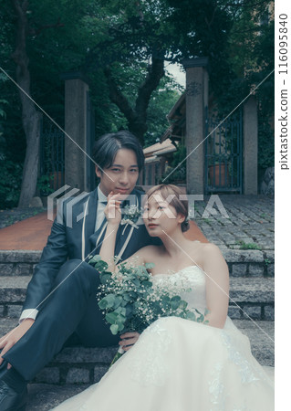 Bride and groom in tuxedo and wedding dress 116095840